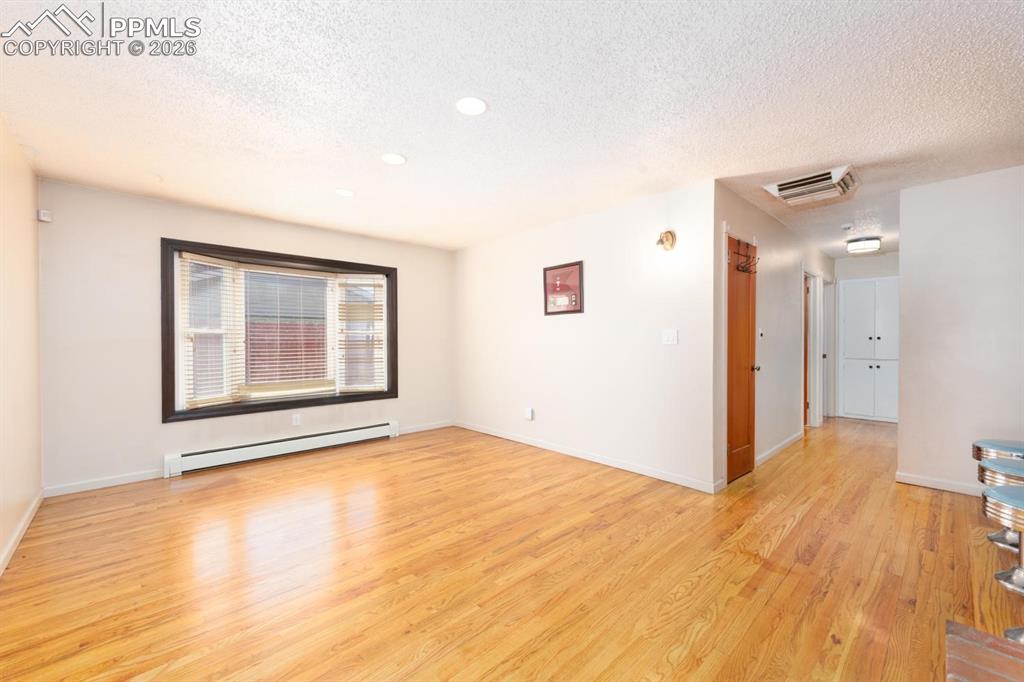 Image 10 of 34: Large dining room that features counter top seating with original stools, t