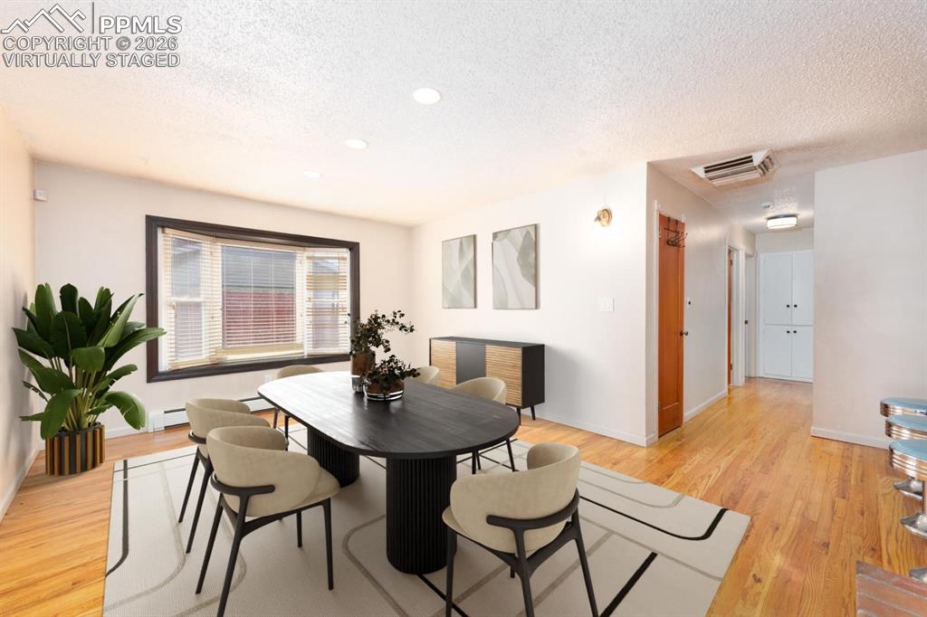 Image 11 of 34: Virtually Staged. Large dining room that features counter top seating with