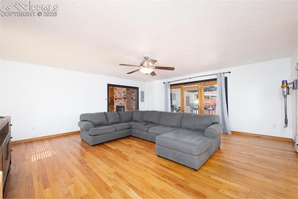 Image 12 of 34: The living room is located off of the dining room. It features large window