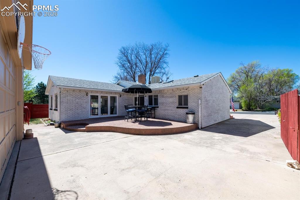 Image 25 of 34: Back patio with access to the kitchen and living room