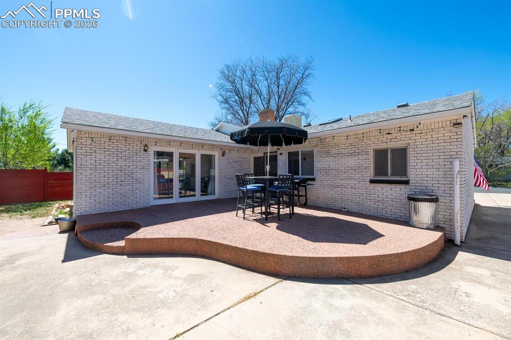Image 26 of 34: Back patio with access to the kitchen and living room