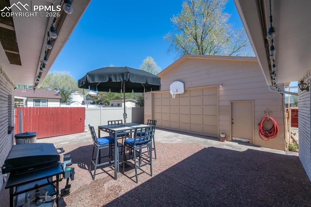 Image 27 of 34: Back patio with access to the kitchen and living room