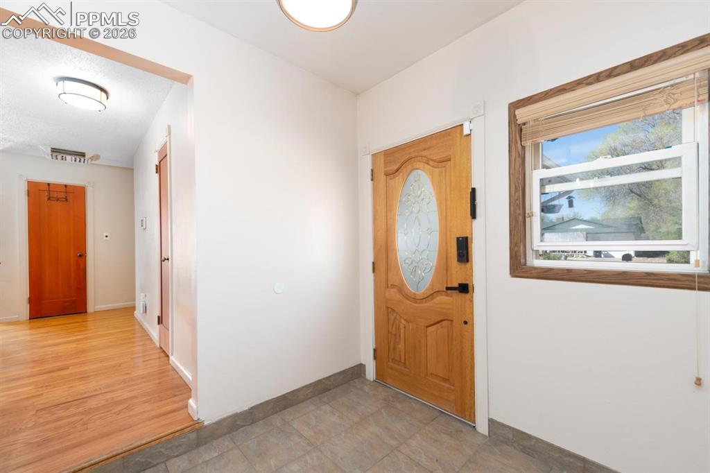 Image 4 of 34: Entryway that leads into the living areas, kitchen, and flex room