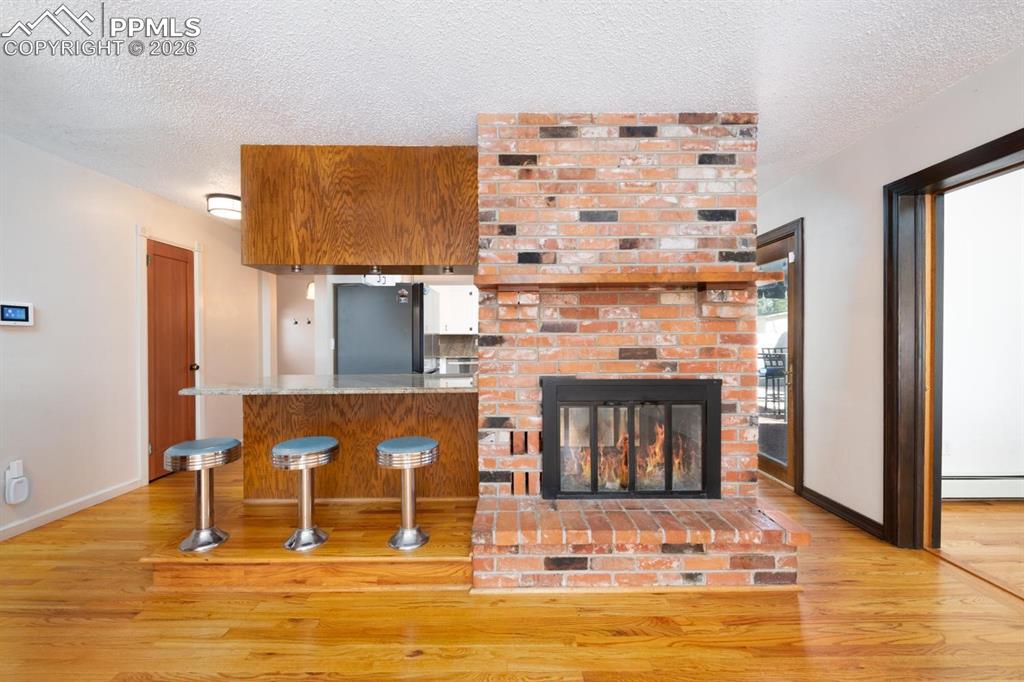 Image 9 of 34: Large dining room that features counter top seating with original stools, t