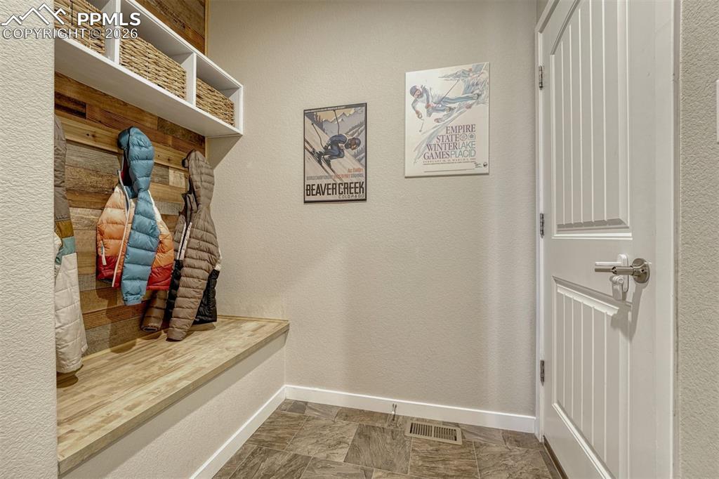 Image 17 of 46: Custom mudroom drop zone with cubbies, hooks, and bench seating