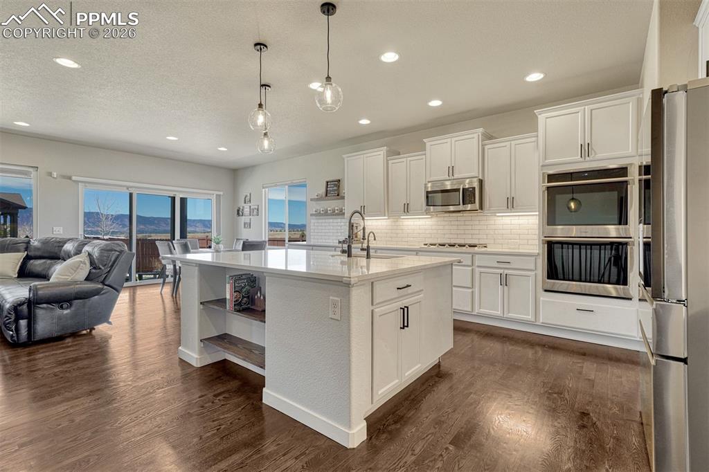 Image 2 of 46: Remodeled kitchen with quartz countertops and oversized island