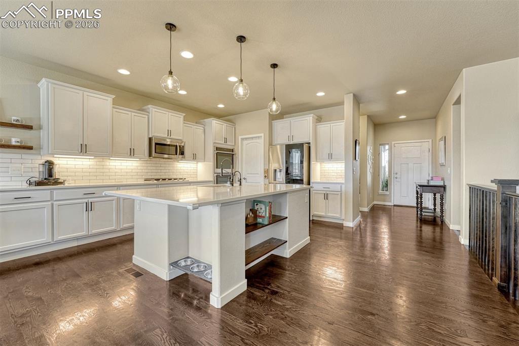 Image 3 of 46: Extended cabinetry and under-cabinet lighting for a modern touc