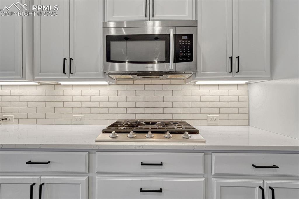 Image 36 of 46: 5-burner gas range and thoughtful upgrades throughout