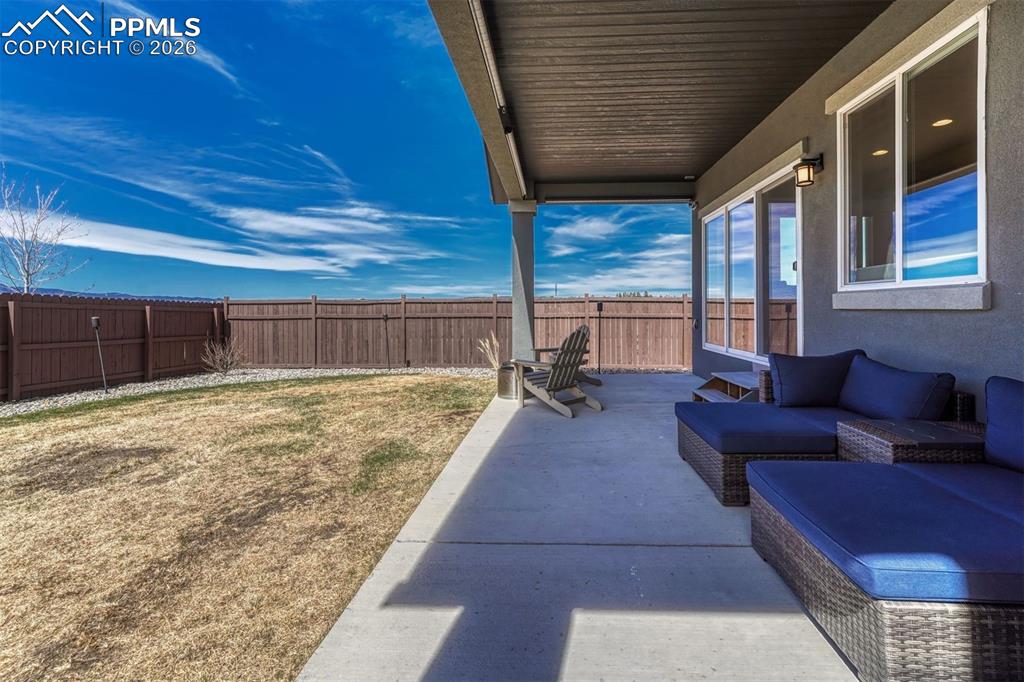Image 39 of 46: Fenced yard and large patio.