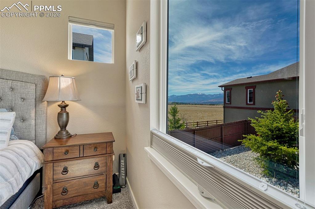 Image 8 of 46: Main-level primary suite with peaceful views