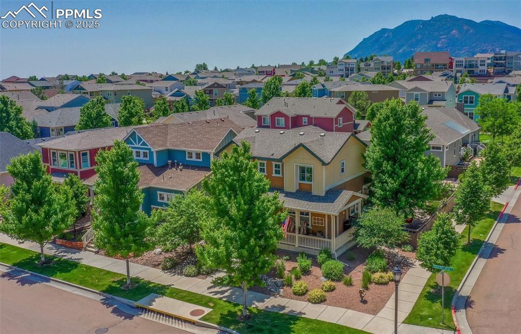 Image 10 of 50: Aerial perspective of suburban area featuring a mountain backdrop
