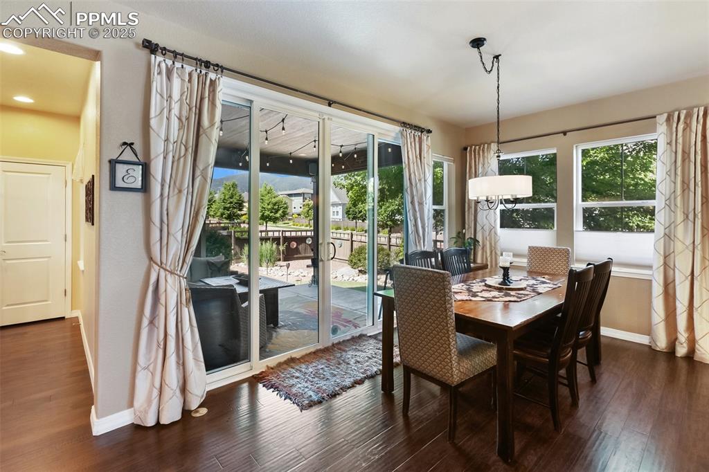 Image 14 of 50: Dining space featuring wood finished floors and recessed lighting