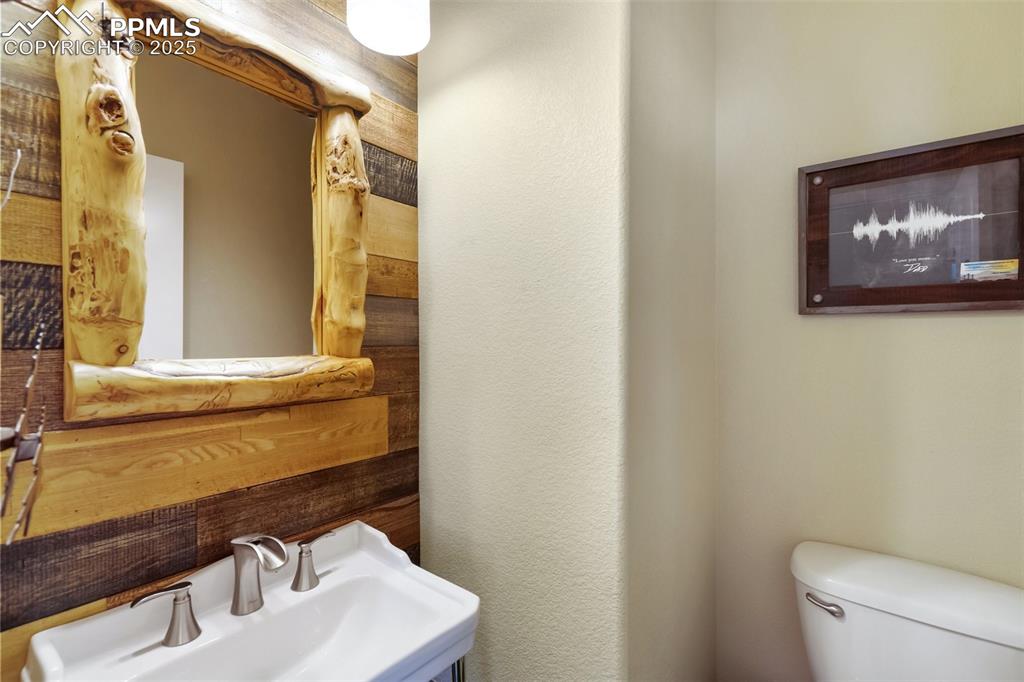 Image 19 of 50: Half bathroom featuring a sink and toilet