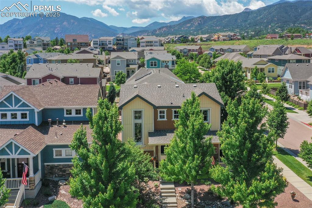 Image 2 of 50: Aerial view of residential area featuring a mountainous background