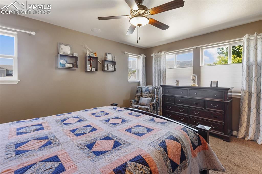 Image 26 of 50: Bedroom featuring light carpet and ceiling fan