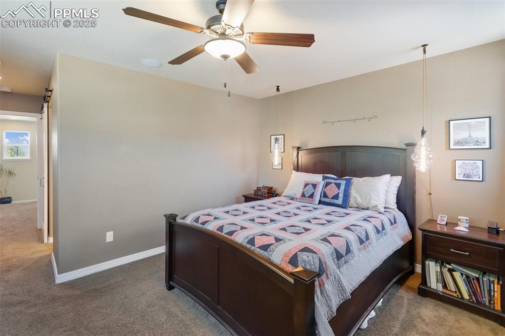 Image 28 of 50: Carpeted bedroom featuring baseboards and ceiling fan