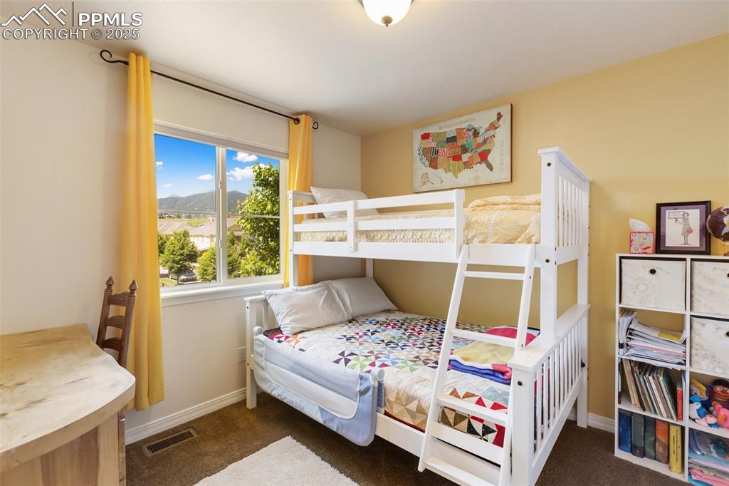 Image 32 of 50: Bedroom with carpet flooring and a mountain view