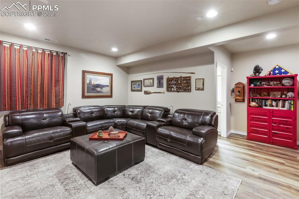 Image 40 of 50: Living room featuring recessed lighting and wood finished floors