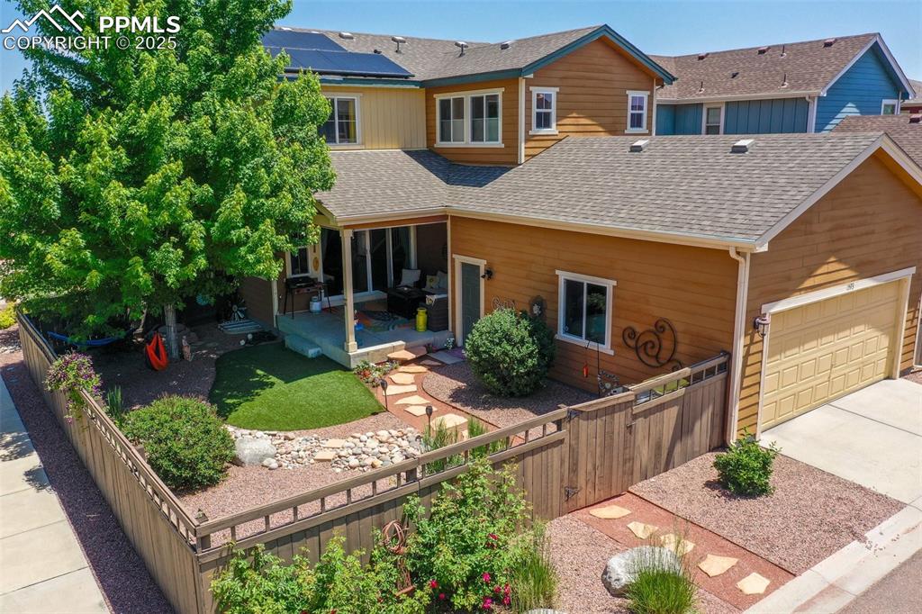 Image 49 of 50: View of front of home featuring roof with shingles, concrete driveway, a fe