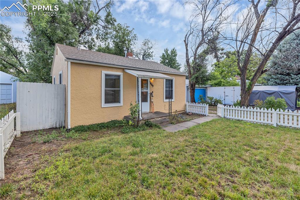 Image 3 of 16: Bungalow-style house with a chimney, stucco siding, and roof with shingles
