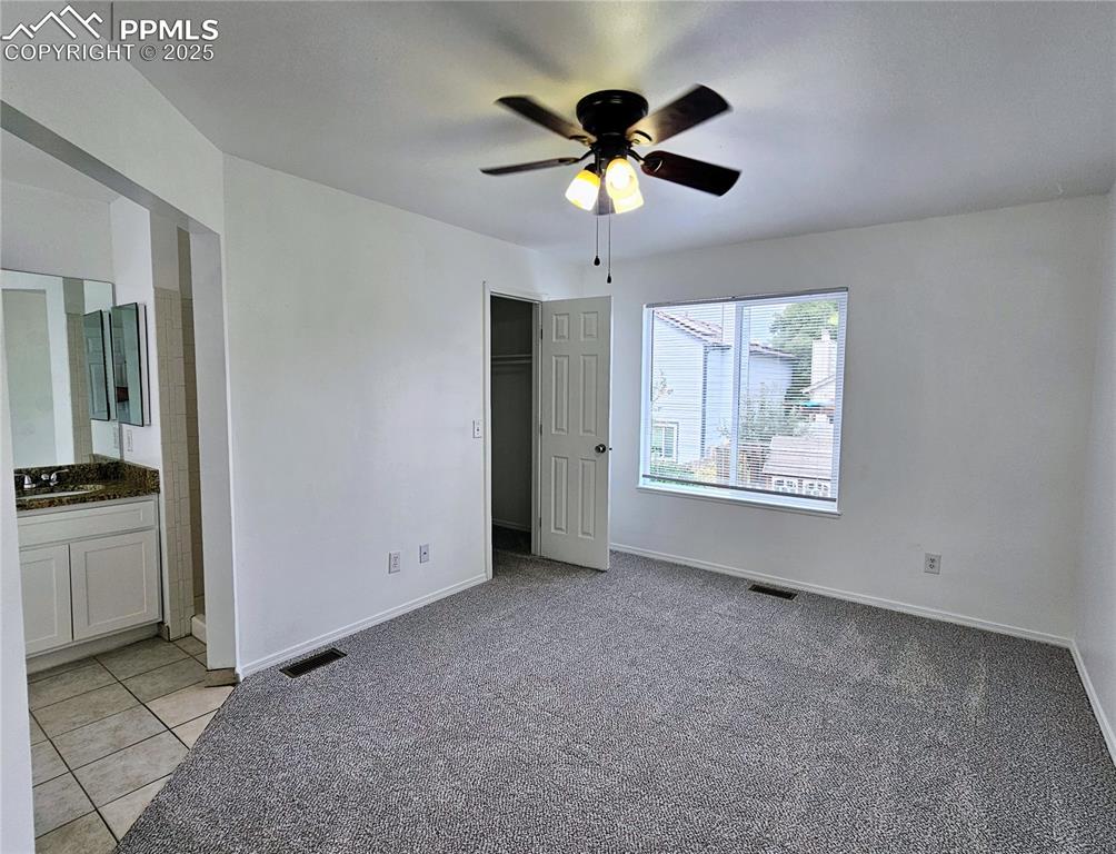 Image 18 of 31: Unfurnished bedroom featuring light carpet, a closet, a ceiling fan, light 