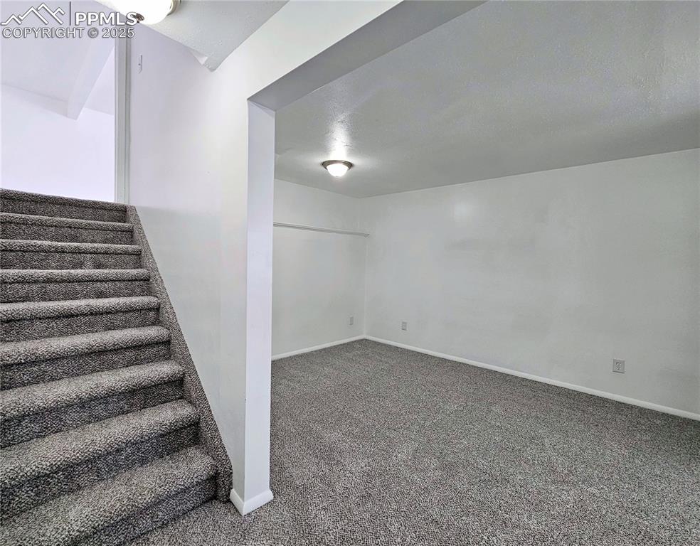 Image 25 of 31: Basement with carpet flooring and stairway