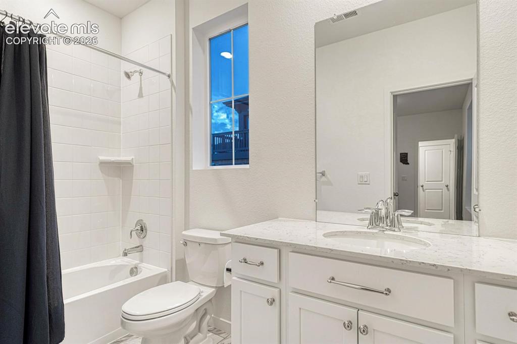 Image 37 of 46: Main level bathroom joins bedroom