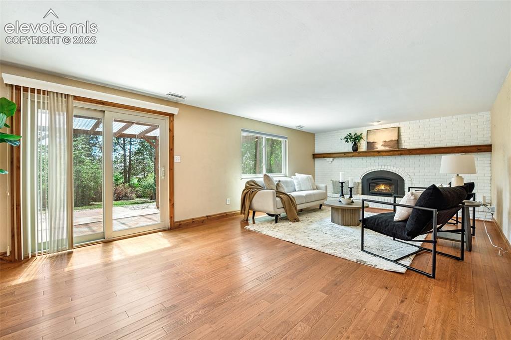 Image 14 of 50: Hardwood flooring and walkout to...