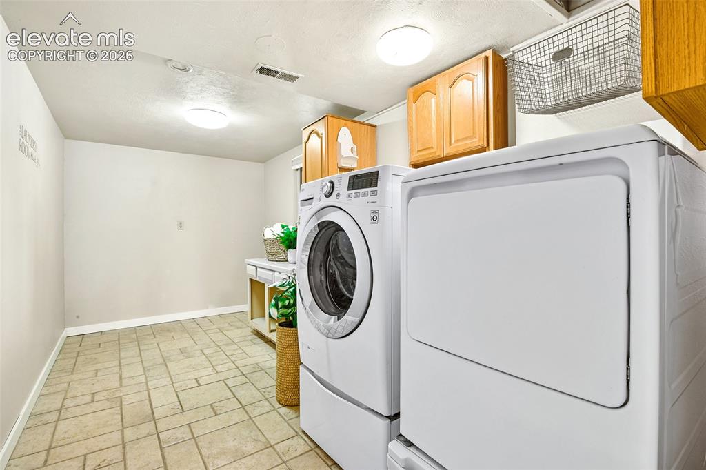 Image 16 of 50: Laundry on lower level with washer and dryer