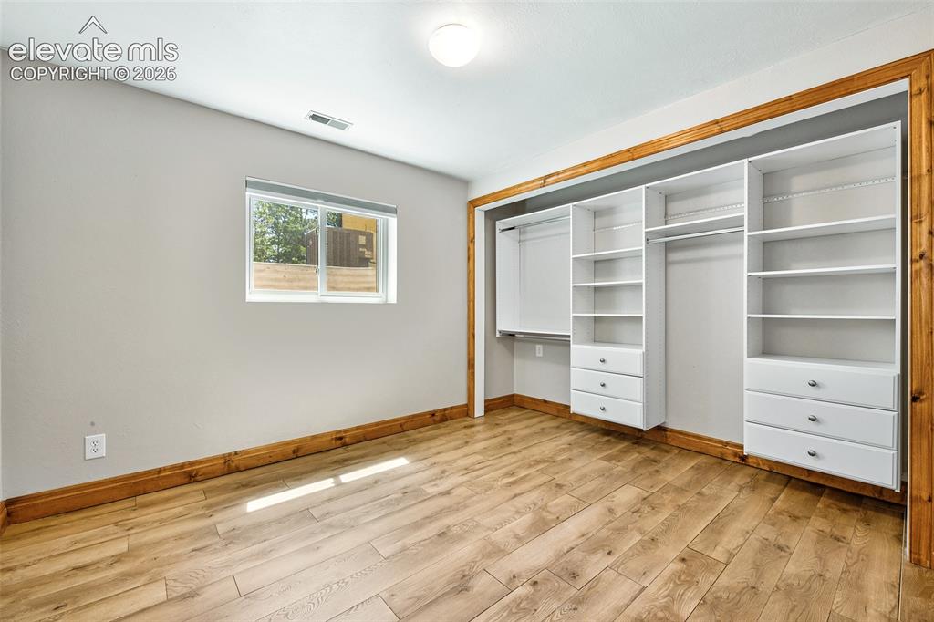 Image 30 of 50: 4th Bedroom in basement with built-ins in closet