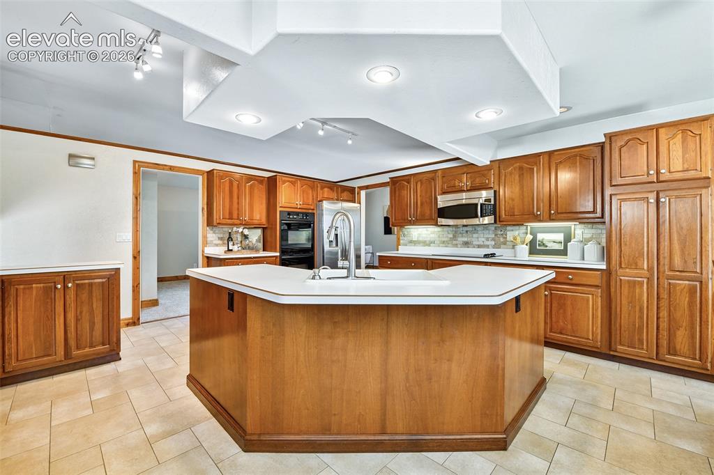 Image 8 of 50: Large kitchen with loads of cabinets with pullouts