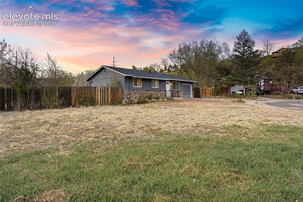 Image 2 of 20: Charming single-story residence with a classic pitched roof and stone exter