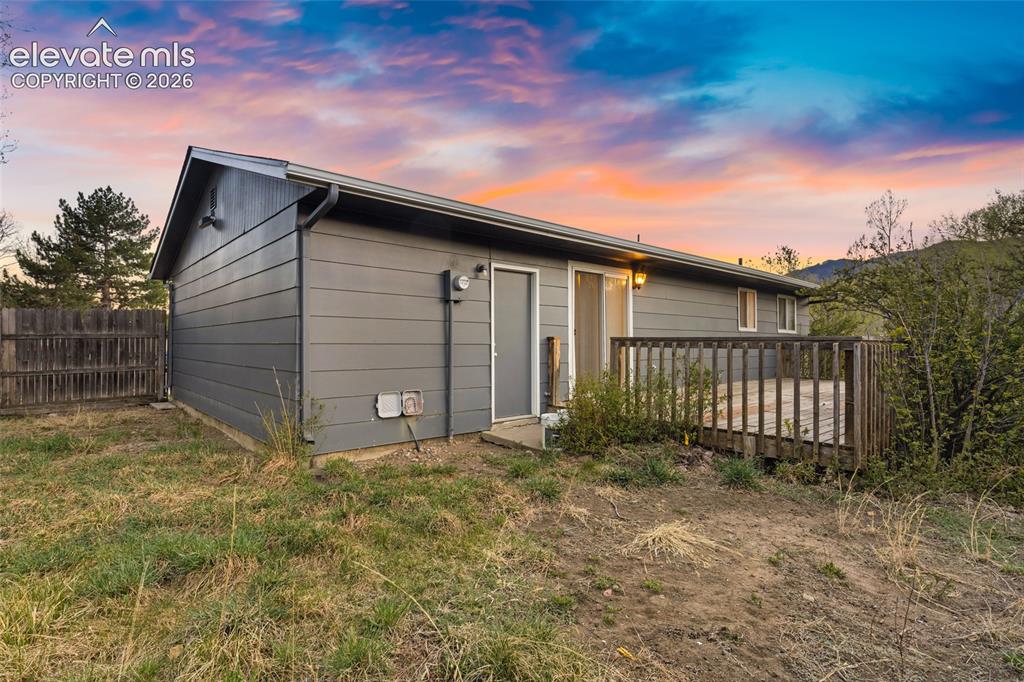 Image 20 of 20: Modern siding exterior with a covered front porch featuring wooden railings