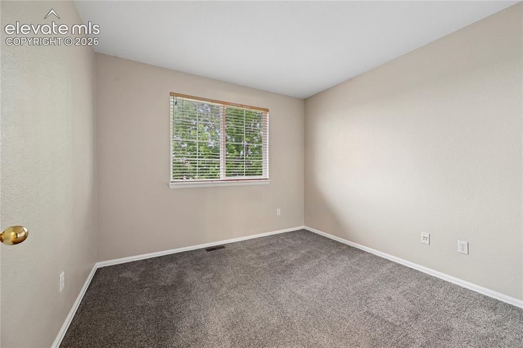 Image 15 of 29: Bedroom #2 of 3 upstairs enjoys the shade of that mature maple tree out fro