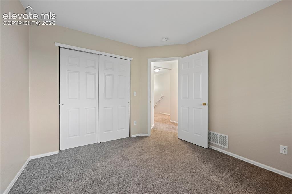 Image 16 of 29: Bedroom #2 of 3 with double-door closet.