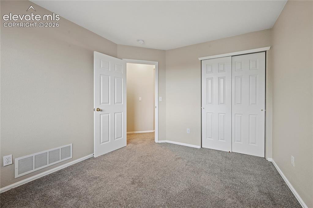 Image 18 of 29: Bedroom #3 of 3 upstairs also has good clean carpets and a double-door clos