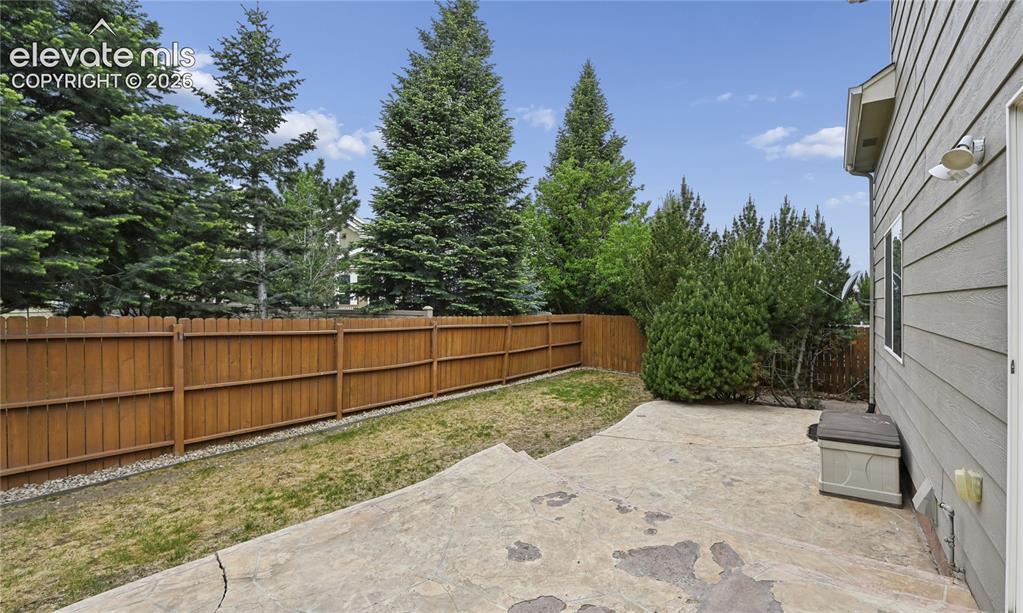 Image 21 of 29: The tree-lined back yard makes this home feel more private than many in the