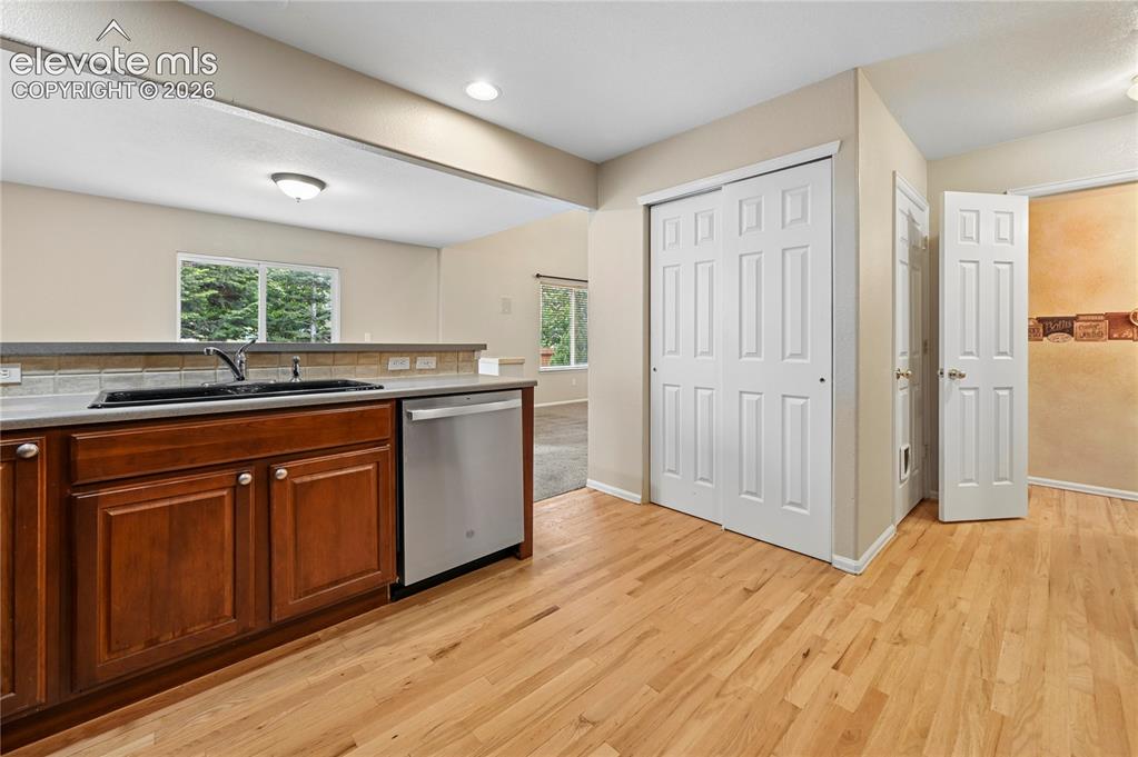 Image 9 of 29: Genuine solid-oak flooring extends to the back hall, main floor half-bath, 