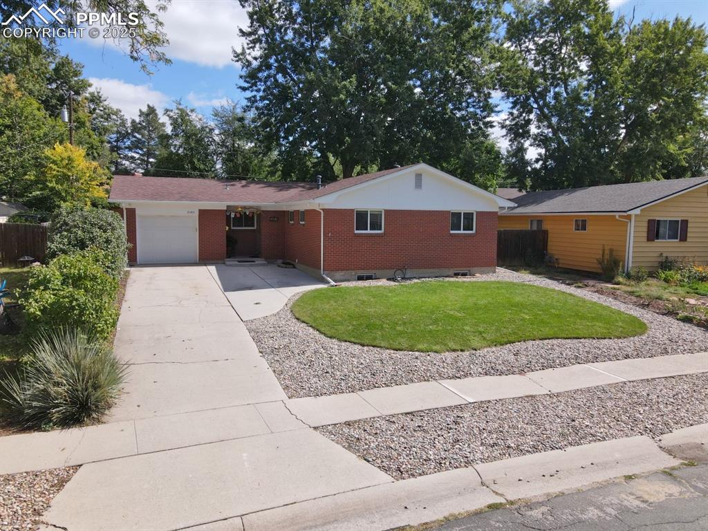 Image 39 of 47: Single story home with brick siding, driveway, and an attached garage