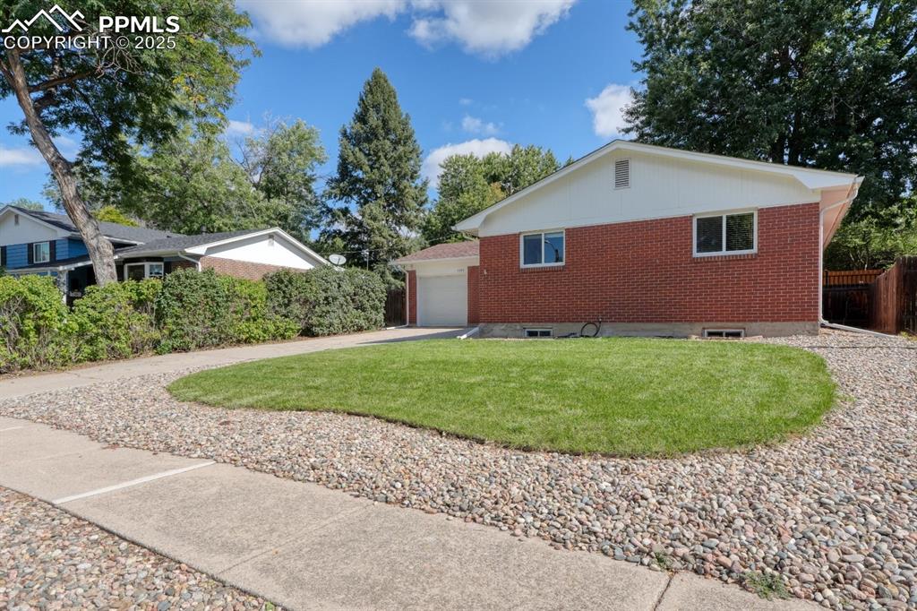 Image 44 of 47: View of front of home featuring brick siding, concrete driveway, and a fron