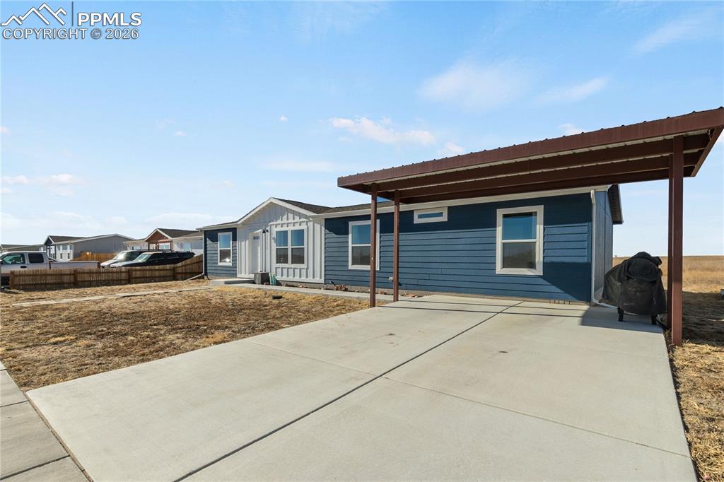 Image 3 of 34: Driveway with 2 car carport.