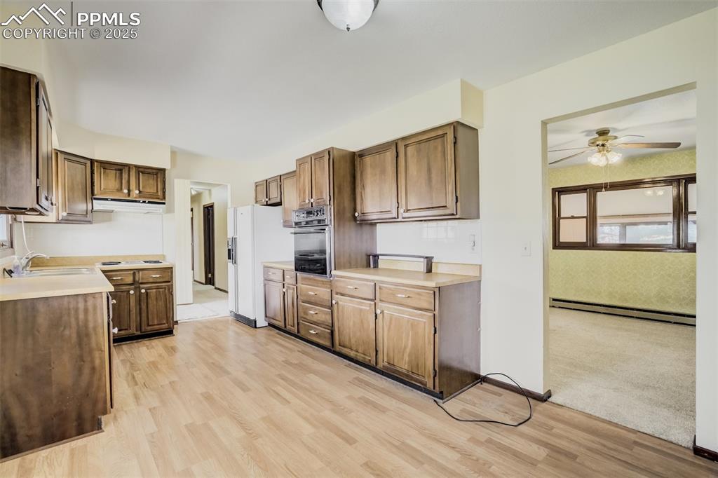 Image 10 of 43: Kitchen and entry to the living room; view from dining room