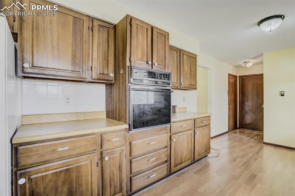 Image 12 of 43: Kitchen with doors to the pantry and garage