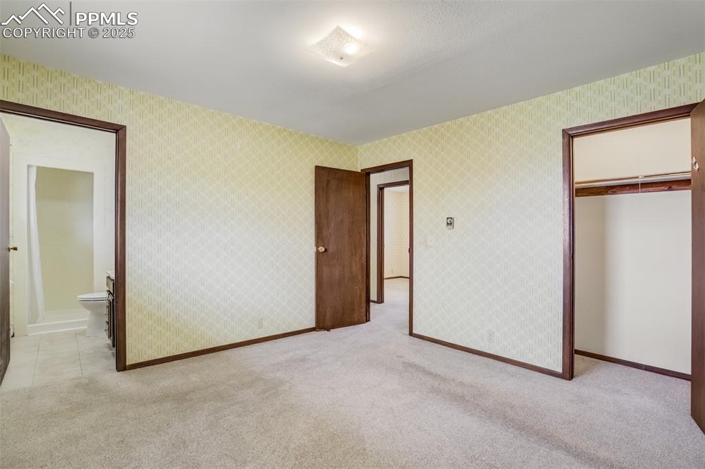 Image 26 of 43: View of Primary Bedroom with entrance, 3/4 bath, and closet.