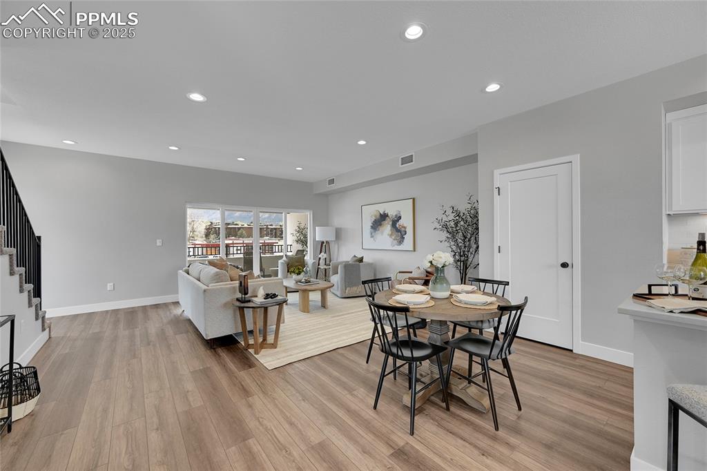 Image 14 of 31: Dining room with stairs, visible vents, light wood-style floors, and recess