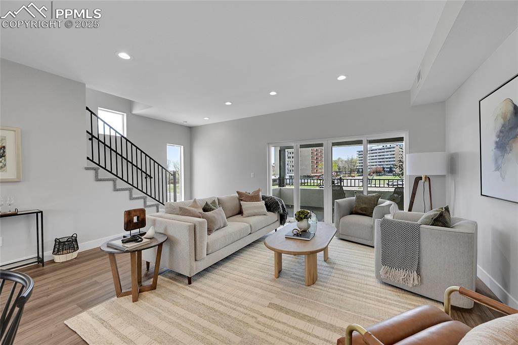 Image 20 of 31: Living area featuring wood finished floors, recessed lighting, and a health