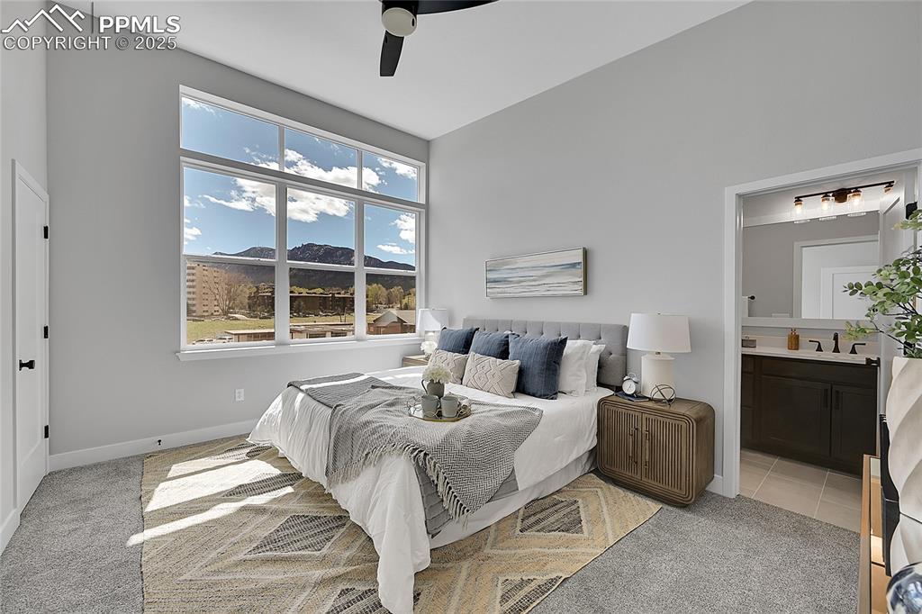Image 22 of 31: Bedroom featuring a sink, a mountain view, ensuite bath, and light colored 