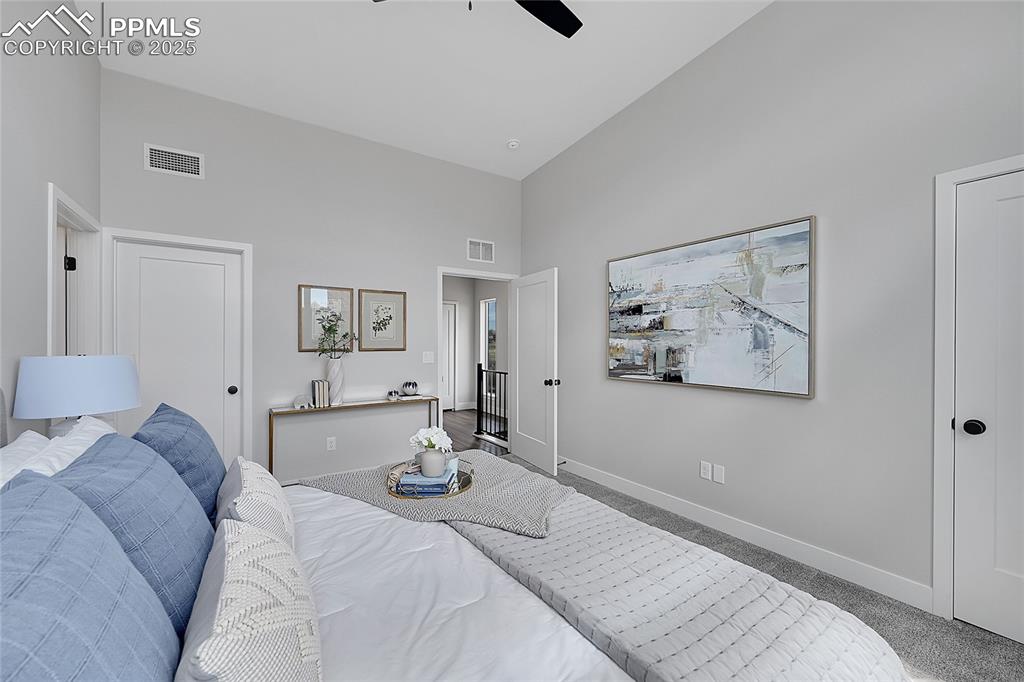 Image 24 of 31: Carpeted bedroom featuring a towering ceiling