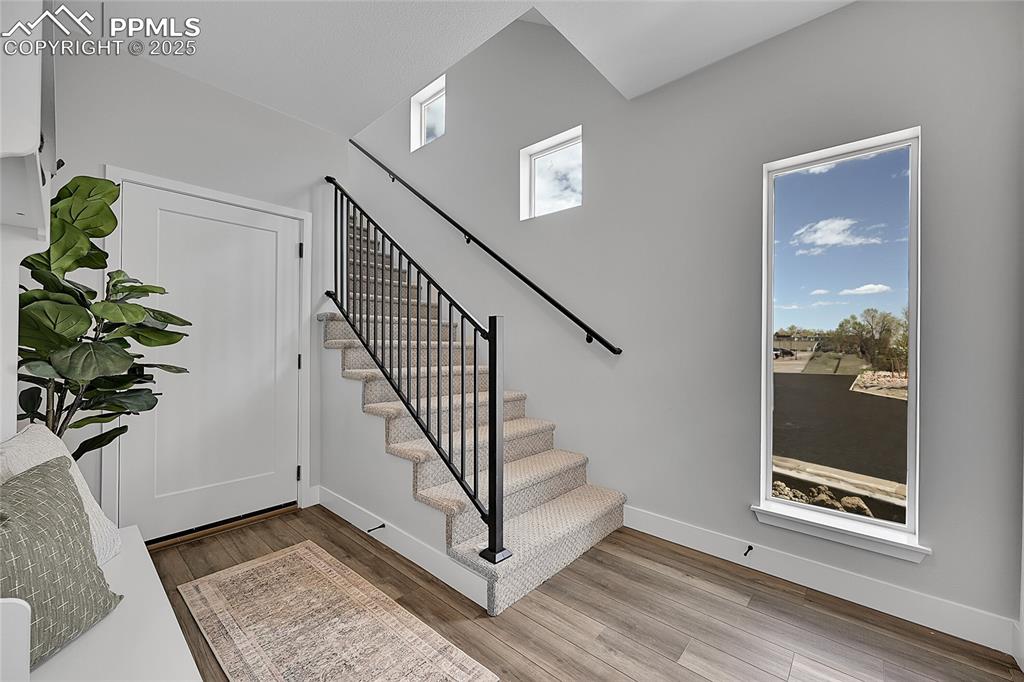 Image 3 of 31: Stairway with wood finished floors
