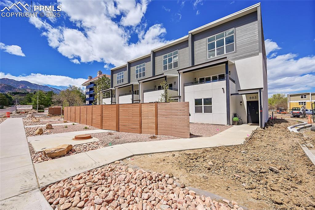 Image 31 of 31: Back of property featuring fence and a mountain view